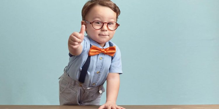 boy in bowtie and glasses gives positive thumbs up