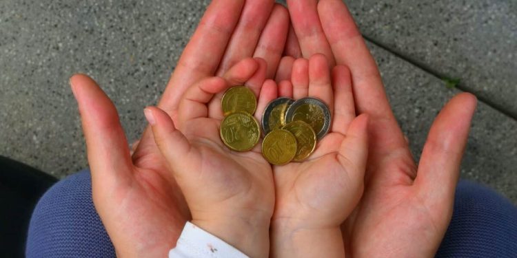 holding coins in hand for the future