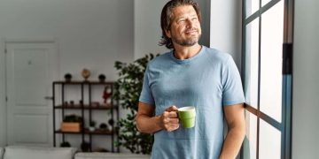 Middle aged man drinks coffee