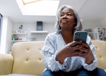 woman looks at iPhone