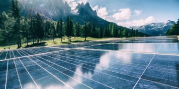 A solar cell panel generates power in a country mountain landscape.