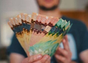Person holds banknotes of Canadian dollars