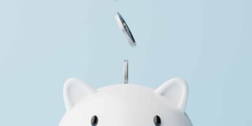 Silver coins fall into a piggy bank.