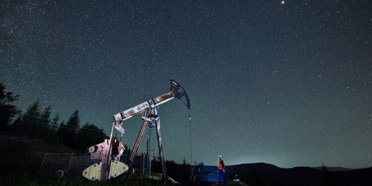 oil pump jack under night sky