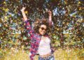 person enjoys shower of confetti outside
