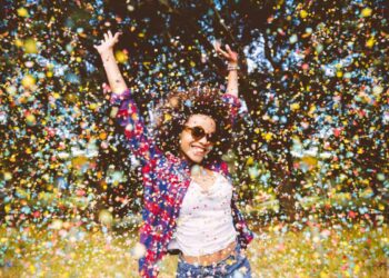 person enjoys shower of confetti outside