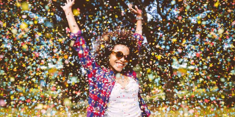 person enjoys shower of confetti outside