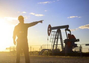 Oil industry worker works in oilfield