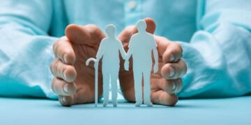 Hand Protecting Senior Couple