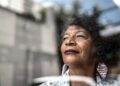 woman gazes forward out window to future