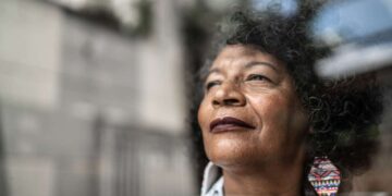woman gazes forward out window to future