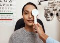 patient tests her eyes with a vision test at a doctor