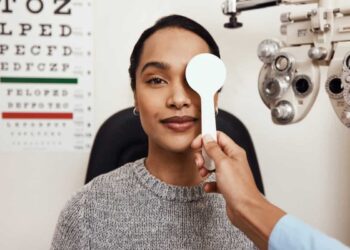 patient tests her eyes with a vision test at a doctor