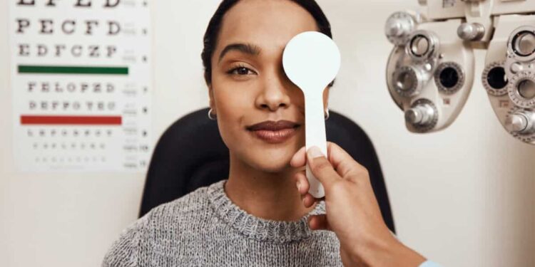 patient tests her eyes with a vision test at a doctor