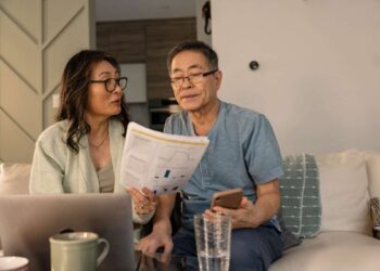 senior couple looks at investing statements