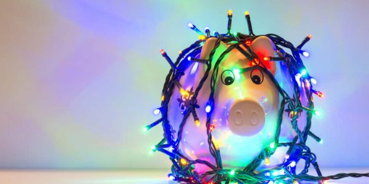 Piggy bank wrapped in Christmas string lights